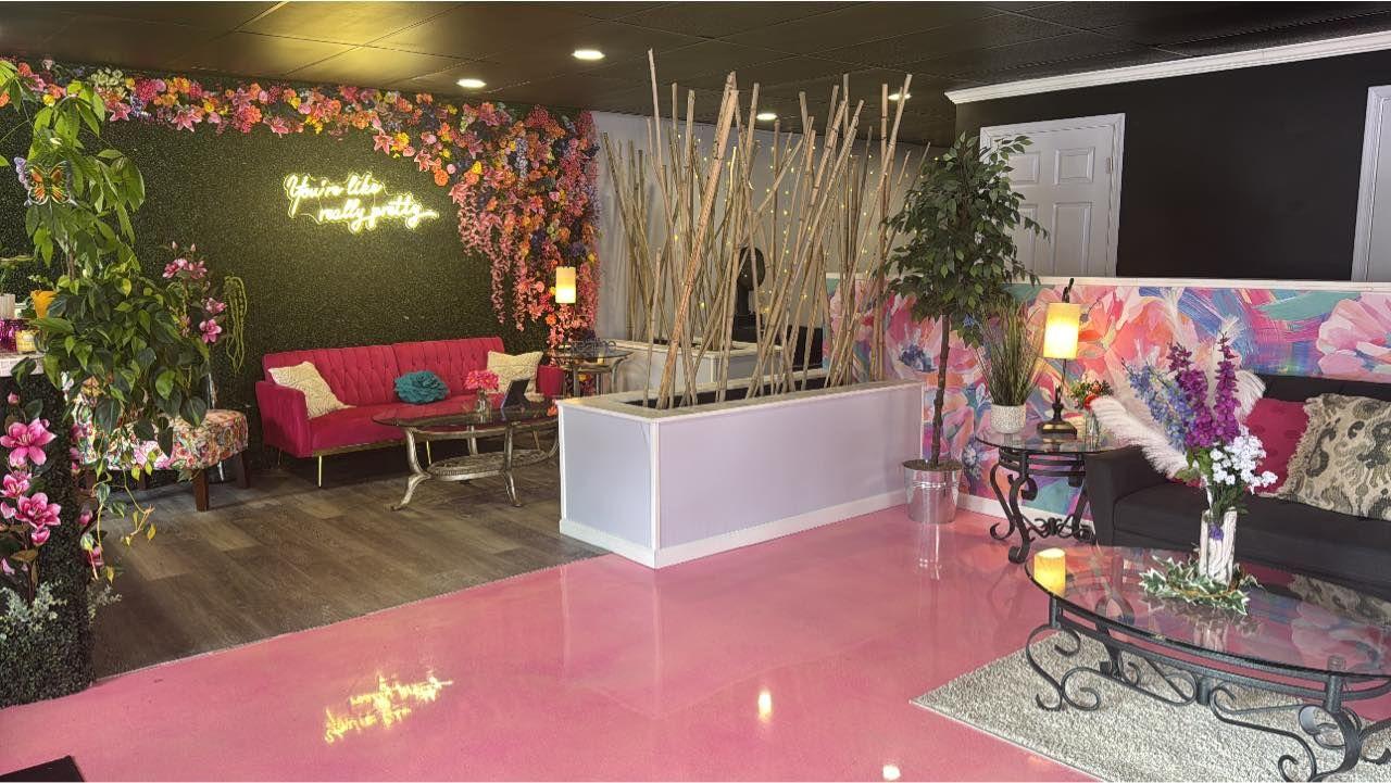 The Pink Room boutique event venue in Stroudsburg, PA with chic pink décor, floral walls, and seating for up to 32 guests.